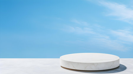Round stone podium in front of a sky blue studio background. White Pedestal for Product Presentationの素材