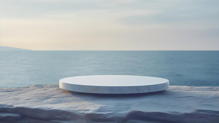 Round Stone Podium in light blue Colors in front of a blurred Seascape. Luxury backdrop for product presentationの素材