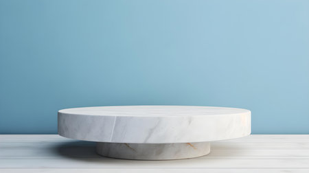 Round stone podium in front of a light blue studio background. White Pedestal for Product Presentationの素材