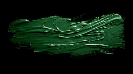 Isolated dark green brush stroke on a black background. Acrylic Paint Texture with Copy Spaceの素材