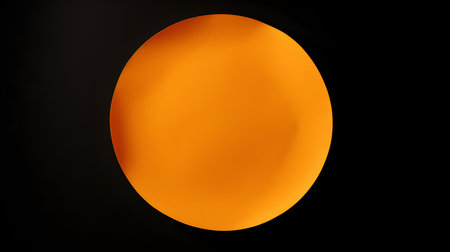 Orange round paper note on a black background. Brainstorming template with copy spaceの素材