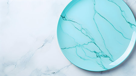 Top view of an empty plate in cyan colors on a white marble background. Elegant template with copy spaceの素材