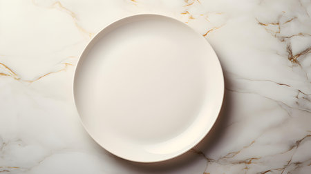 Top view of an empty plate in ivory colors on a white marble background. Elegant template with copy spaceの素材