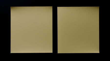Two Khaki square paper notes on a black background. Brainstorming template with copy spaceの素材