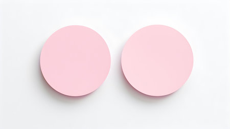 Two light pink round paper notes on a white background. Brainstorming template with copy spaceの素材