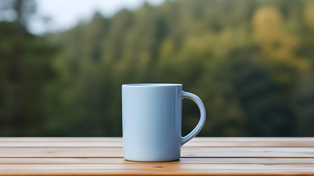 Close up of a light blue mug on a wooden table in a forest. Blurred natural backgroundの素材