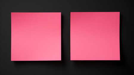Two pink square paper notes on a black background. Brainstorming template with copy spaceの素材