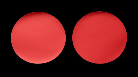 Two light red round paper notes on a black background. Brainstorming template with copy spaceの素材