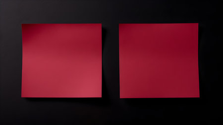 Two red square paper notes on a black background. Brainstorming template with copy spaceの素材