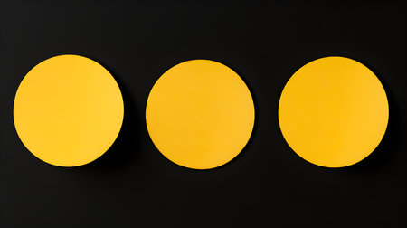 Set of yellow round paper notes on a black background. Brainstorming template with copy spaceの素材