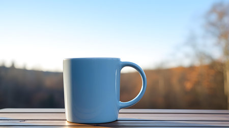 Close up of a sky blue mug on a wooden table in a forest. Blurred natural backgroundの素材
