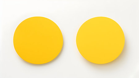 Two yellow round paper notes on a white background. Brainstorming template with copy spaceの素材