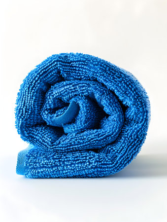 Rolled blue towel on a white backgroundの素材