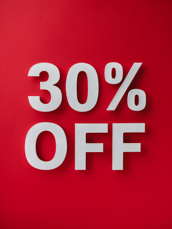 White '30% OFF' Promotional Sign on a Ruby Backgroundの素材