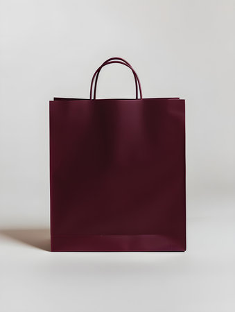 Burgundy shopping bag on a white backgroundの素材