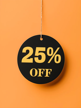Black '25% OFF' Promotional Sign on a Light Orange Backgroundの素材