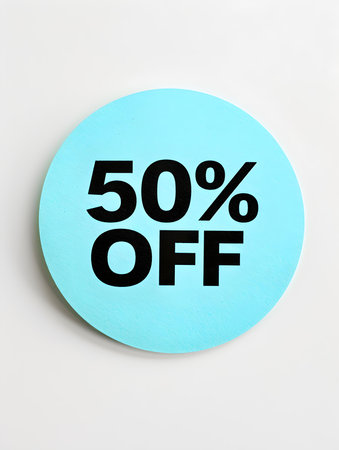Black '50% OFF' Text on a Cyan Round Paper Note. White Backgroundの素材