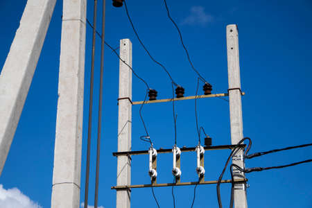 Electricity post with wires against the blue sky. High quality photoの写真素材