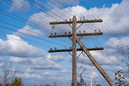 Electricity post with wires against the blue sky. High voltage post.