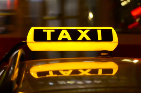 Taxi sign at night の写真素材