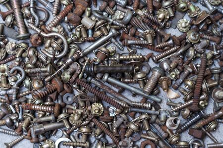 Screw-bolts and nuts background. Top view, horizontal.