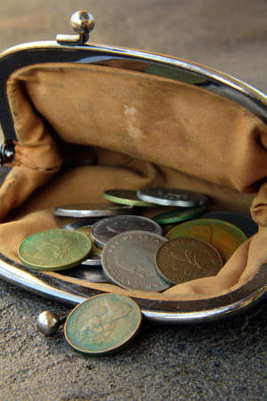 ancient coins in the open vintage purse on a black backgroundの写真素材