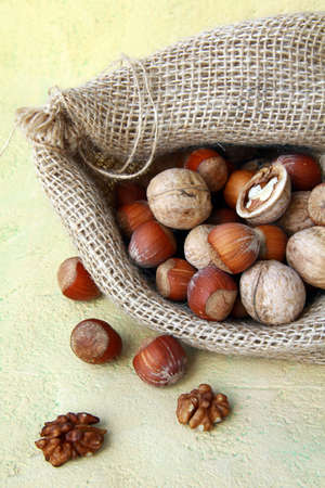 hazelnuts and walnuts in a linen bagの写真素材