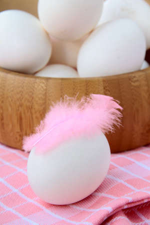 wooden bowl with eggs and feathers rustic styleの写真素材
