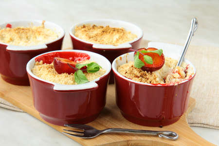 crumble plum dessert  with mint in a cup の写真素材