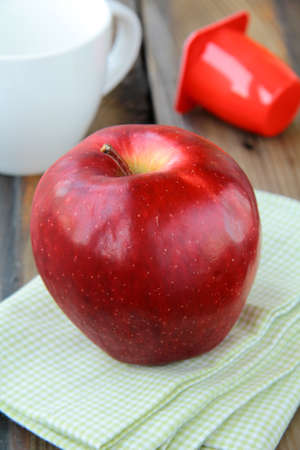 big red apple on a napkin - a healthy breakfastの写真素材