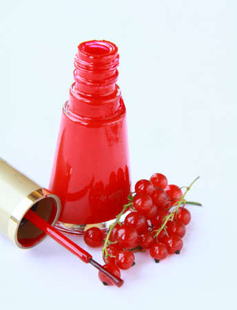 red nail polish and red currant berries の写真素材