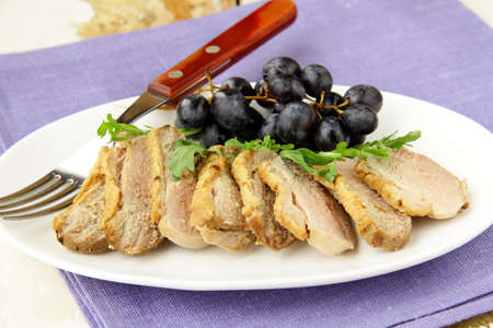 cooked meat duck with berry sauce and salad on a plate の写真素材