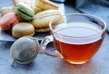 french dessert macaroons and a cup of tea の写真素材