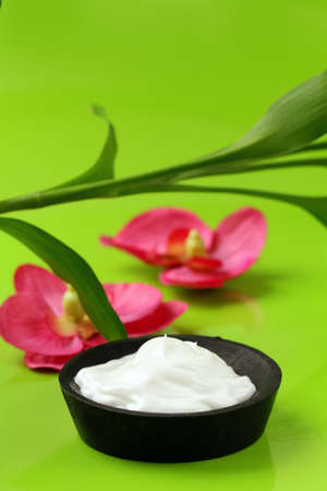 cream for face and body  on a green background, spa conceptの写真素材