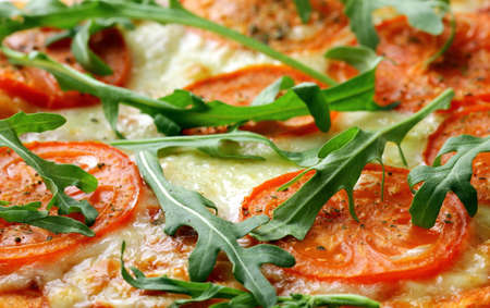 Margarita pizza with tomatoes and with arugula,  on the board の写真素材