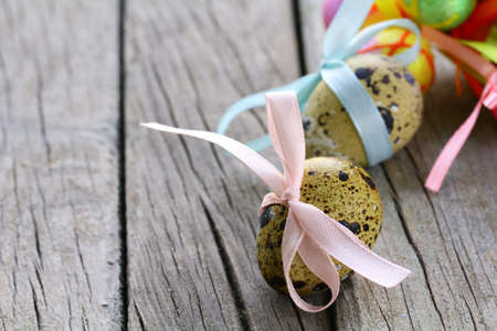Easter quail eggs on wooden background の写真素材