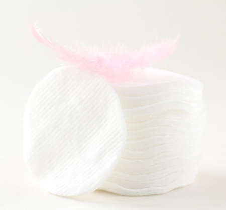 cotton cosmetic disks sponges with a pink featherの写真素材