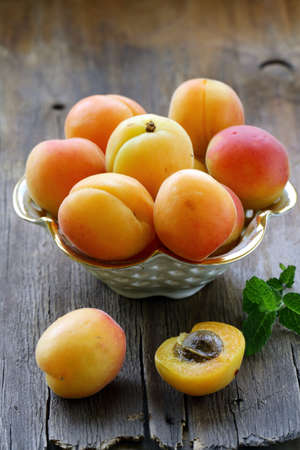 Group ripe juicy fruit apricot on a wooden table, rustic styleの写真素材