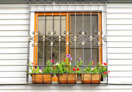 window on the wall, decorated with flowers and the lattice