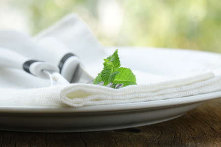 cutlery, fork and knife on a white plateの写真素材