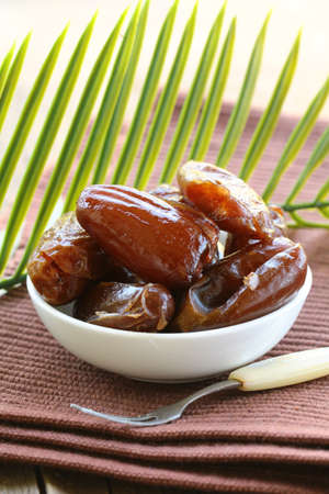 sweet dates in  bowl on a natural backgroundの写真素材