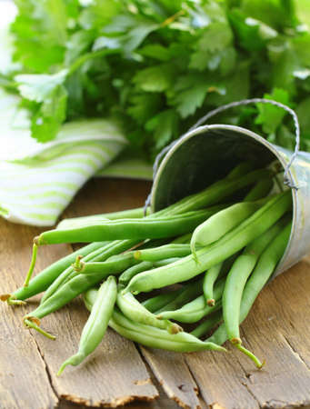 pods of green peas on a wooden table, rustic style