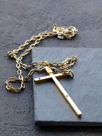gold cross on a black background - a religion symbolの写真素材