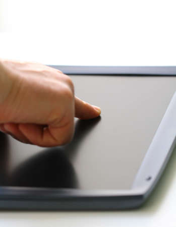 man hand and touch screen display  shallow soft focus on finger 