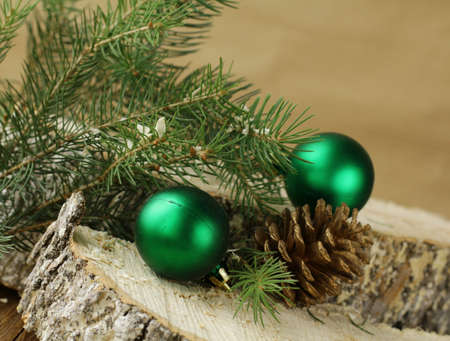 green fir branches and christmas decorations  on a wooden backgroundの写真素材