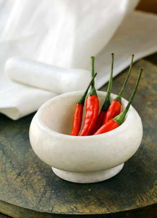 red hot chili peppers in a marble mortarの写真素材