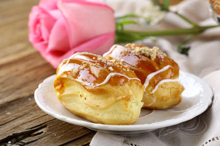 cakes eclair profiteroles on a plate - a dessert for two