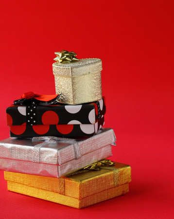 colorful stack of gift boxes on a pink background