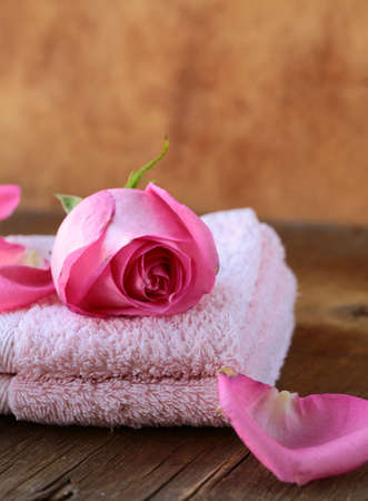 Spa concept with rose petals on a wooden backgroundの写真素材