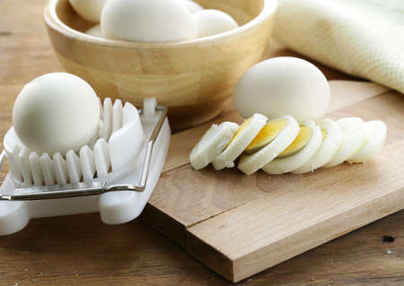 sliced boiled egg for salad on the boardの写真素材